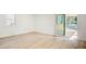 Bright living room with light wood floors, a sliding glass door to the deck, and a large window at 4544 Savage Ne Dr, Marietta, GA 30066