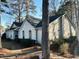 A one-story home featuring arched windows and mature trees at 9921 Al Cooper Trce, Jonesboro, GA 30238