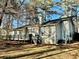 A one-story home featuring a deck, large windows, and a chimney at 9921 Al Cooper Trce, Jonesboro, GA 30238