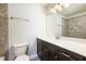 Well-lit bathroom features a modern vanity, stone-look tile, and a large mirror at 1026 Township Sq, Alpharetta, GA 30022