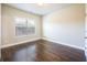 Bedroom with dark hardwood flooring, a large window and neutral paint at 1026 Township Sq, Alpharetta, GA 30022