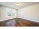 Bedroom features a large window, neutral paint and hardwood flooring at 1026 Township Sq, Alpharetta, GA 30022