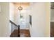 Bright entryway with wood floors, an elegant light fixture, and a staircase with iron railings at 1026 Township Sq, Alpharetta, GA 30022