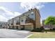 Townhome exterior showcasing a brick and siding facade with garages and manicured lawn at 1026 Township Sq, Alpharetta, GA 30022
