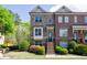 Charming brick townhome featuring a landscaped front yard and inviting entryway steps at 1026 Township Sq, Alpharetta, GA 30022
