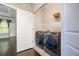 Laundry room featuring a dark gray washer and dryer, shelving and hardwood floors at 1026 Township Sq, Alpharetta, GA 30022