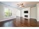 Spacious living room featuring hardwood floors, a fireplace, and large windows for natural light at 1026 Township Sq, Alpharetta, GA 30022