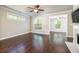 Bright living room featuring hardwood floors, a fireplace, and seamless flow to other living spaces at 1026 Township Sq, Alpharetta, GA 30022