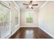 Cozy sunroom with hardwood floors, large windows and access to an outdoor deck at 1026 Township Sq, Alpharetta, GA 30022