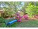 Secluded backyard oasis with a comfortable bench surrounded by vibrant azalea bushes at 1187 Newbridge Ne Trce, Atlanta, GA 30319