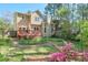 Charming backyard featuring a wooden deck, lush greenery, and colorful flowering shrubs at 1187 Newbridge Ne Trce, Atlanta, GA 30319