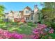 Well-manicured backyard featuring a deck, lush landscaping, and a charming brick path at 1187 Newbridge Ne Trce, Atlanta, GA 30319