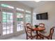 Cozy breakfast nook with natural light, wood table, and view to the outdoor patio at 1187 Newbridge Ne Trce, Atlanta, GA 30319