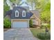 Charming home with a two-car garage, manicured lawn, and mature trees at 1187 Newbridge Ne Trce, Atlanta, GA 30319