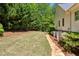 Large backyard with a stone walkway, mature trees, and a well-maintained lawn at 155 Palmer Oaks Ln, Marietta, GA 30068