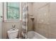 Cozy bathroom featuring tiled walls, patterned shower curtain, window and shelf space at 155 Palmer Oaks Ln, Marietta, GA 30068