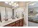 Neutral bathroom with a double sink vanity and large mirror with a view to the bedroom at 155 Palmer Oaks Ln, Marietta, GA 30068