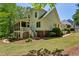 Two-story home with a covered patio, mature landscaping, and a well-maintained lawn at 155 Palmer Oaks Ln, Marietta, GA 30068