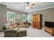 Cozy living room with a comfortable couch, chair and ottoman, and built-in wooden storage cabinets at 155 Palmer Oaks Ln, Marietta, GA 30068