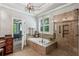 Luxurious main bathroom showcasing a tiled shower with glass door and separate tub with natural light at 155 Palmer Oaks Ln, Marietta, GA 30068