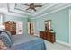 Open view of the calming main bedroom showcasing trey ceilings, ceiling fan, and detailed wood furniture at 155 Palmer Oaks Ln, Marietta, GA 30068