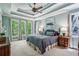 Spacious main bedroom boasts trey ceilings, ceiling fan, large windows and calming paint colors at 155 Palmer Oaks Ln, Marietta, GA 30068