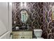 Stylish powder room with unique wallpaper and a decorative mirror at 155 Palmer Oaks Ln, Marietta, GA 30068