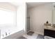 Bright bathroom featuring a large soaking tub, a separate shower, and dark wood cabinets at 309 Daffodil Dr, Temple, GA 30179