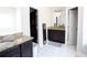 Bathroom featuring double vanity with granite countertop and white tile floors at 309 Daffodil Dr, Temple, GA 30179