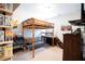 Cozy bedroom with wooden lofted bed frame, desk, seating area, carpet, and closet at 309 Daffodil Dr, Temple, GA 30179