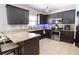 Well-equipped kitchen featuring granite countertops, stainless steel appliances, and dark wood cabinetry at 309 Daffodil Dr, Temple, GA 30179