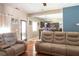 Comfortable living room with hardwood floors, neutral paint, and an open view into the kitchen at 309 Daffodil Dr, Temple, GA 30179