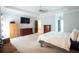 Spacious main bedroom with tray ceiling, carpet, and neutral colors with sitting area at 309 Daffodil Dr, Temple, GA 30179