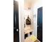 Mudroom with built in bench and storage, black doors, 'keys' wall decor at 309 Daffodil Dr, Temple, GA 30179