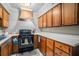 Efficient kitchen with wood cabinets, white countertops, and sleek black appliances at 3105 Colonial Way # F, Atlanta, GA 30341