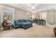 Bright living room featuring a cozy blue sofa, large windows, and a sliding glass door at 3105 Colonial Way # F, Atlanta, GA 30341