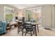 Bright living room with a large table, sliding glass doors to the balcony, and a comfortable blue sofa at 3105 Colonial Way # F, Atlanta, GA 30341