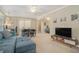 Open-concept living room featuring a blue sofa, dining area, and access to an outdoor space at 3105 Colonial Way # F, Atlanta, GA 30341