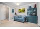 Cozy living room featuring a stylish blue sofa, custom shelving and a doorway to another room at 3105 Colonial Way # F, Atlanta, GA 30341