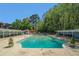 Community pool surrounded by lush greenery, perfect for swimming and relaxing on sunny days at 3105 Colonial Way # F, Atlanta, GA 30341