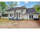 Well-maintained back exterior featuring a screened-in porch, spacious patio, and manicured yard offers outdoor enjoyment at 5663 Brookstone Nw Dr, Acworth, GA 30101