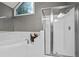 Bathroom boasting a large soaking tub and a glass-enclosed shower with white tile at 5663 Brookstone Nw Dr, Acworth, GA 30101
