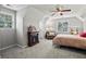 Cozy bedroom with vaulted ceiling, fireplace, sitting area, and natural light at 5663 Brookstone Nw Dr, Acworth, GA 30101