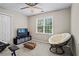 Bright bedroom with a comfortable chair and recreational area, illuminated by a window at 5663 Brookstone Nw Dr, Acworth, GA 30101