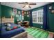 Colorful bedroom with green walls, soccer decor, and a large window with blue curtains at 5663 Brookstone Nw Dr, Acworth, GA 30101