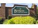 Brookstone: A Country Club Community entrance sign flanked by brick columns and a vibrant yellow flower bed at 5663 Brookstone Nw Dr, Acworth, GA 30101