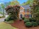 Charming brick home featuring a manicured lawn and mature trees surrounding the property at 5663 Brookstone Nw Dr, Acworth, GA 30101