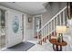 Inviting foyer features tiled flooring, white wainscotting, a staircase, and a decorative glass front door at 5663 Brookstone Nw Dr, Acworth, GA 30101