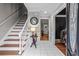 Elegant foyer with staircase, hardwood flooring, and stylish decor creating an inviting entrance to the home at 5663 Brookstone Nw Dr, Acworth, GA 30101