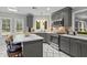 Well-lit kitchen featuring white tile floors, gray cabinets, stainless appliances and breakfast bar with sleek design at 5663 Brookstone Nw Dr, Acworth, GA 30101